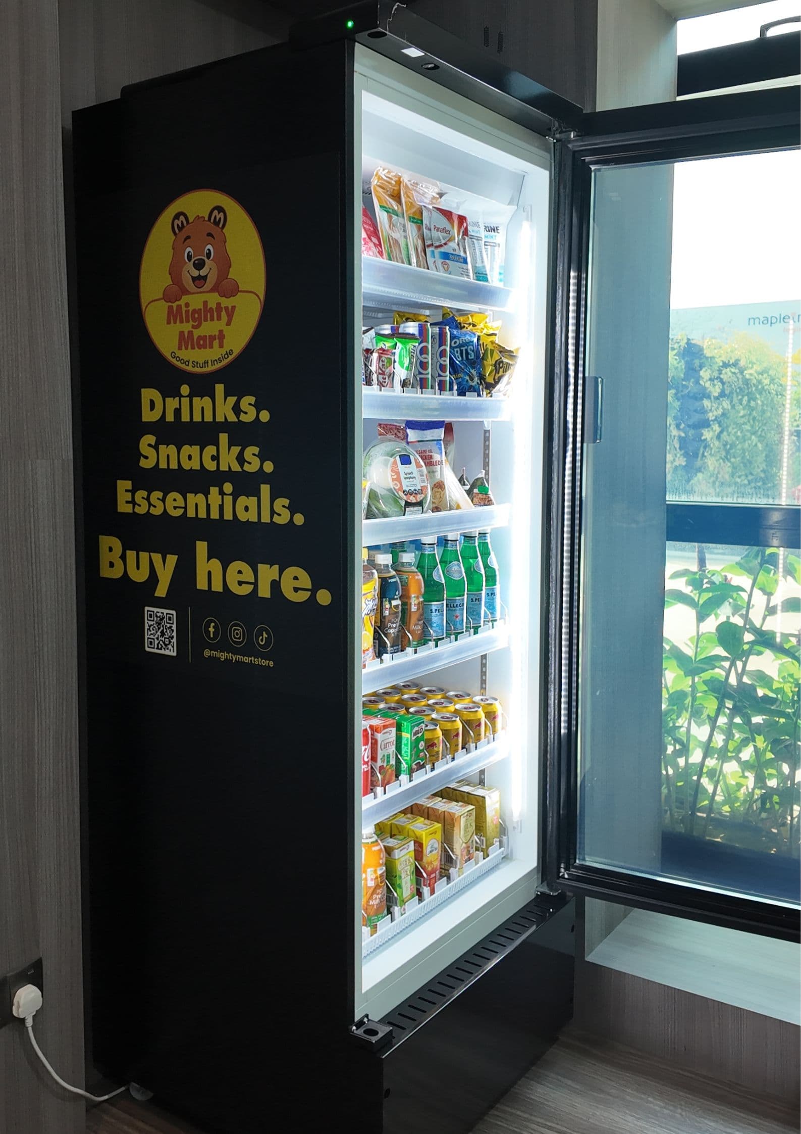 Mighty Mart smart fridge with its door open, stocked with drinks, snacks, meals and everyday essentials