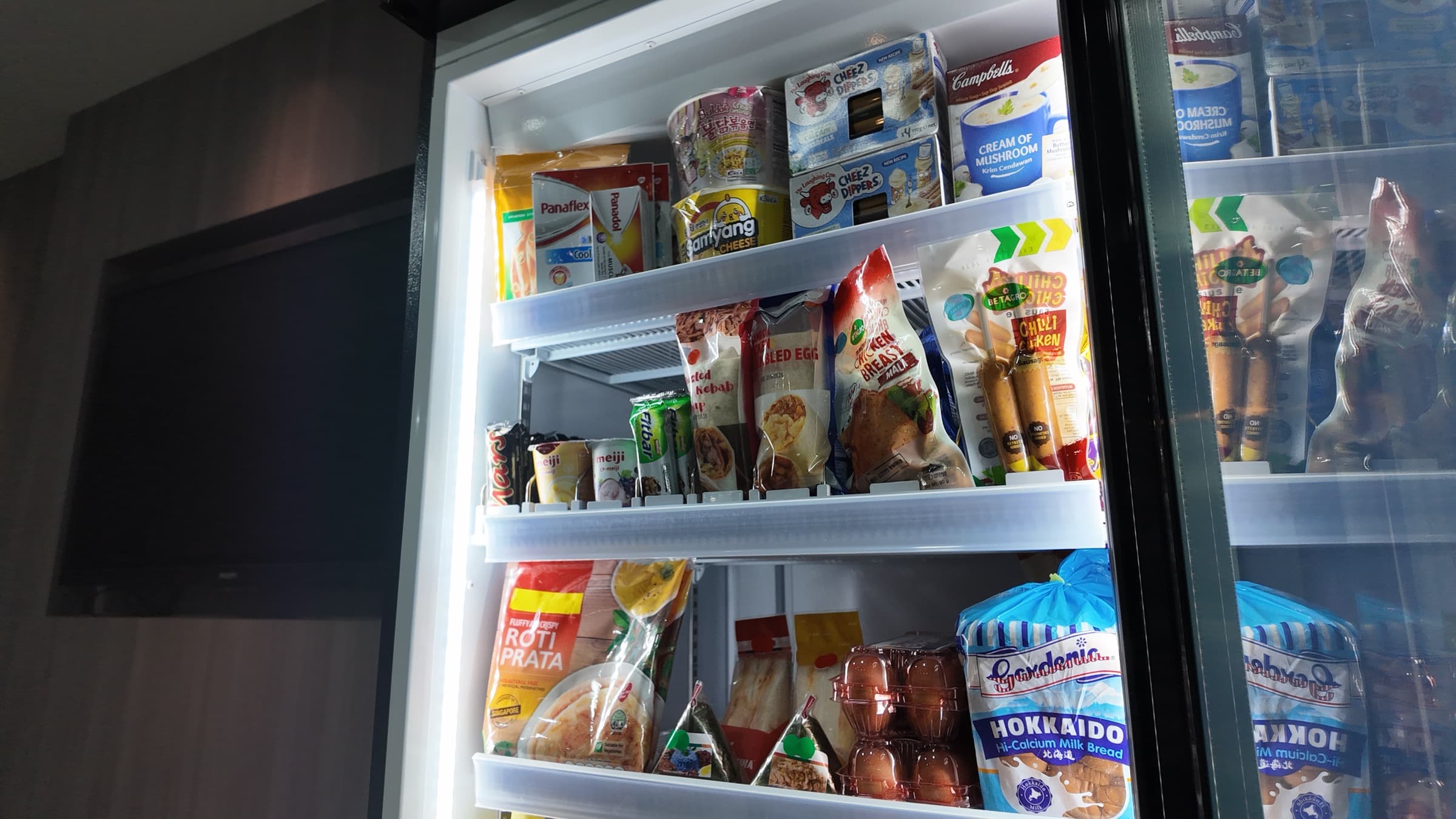 Close-up of Mighty Mart fridge shelves stocked with everyday essentials